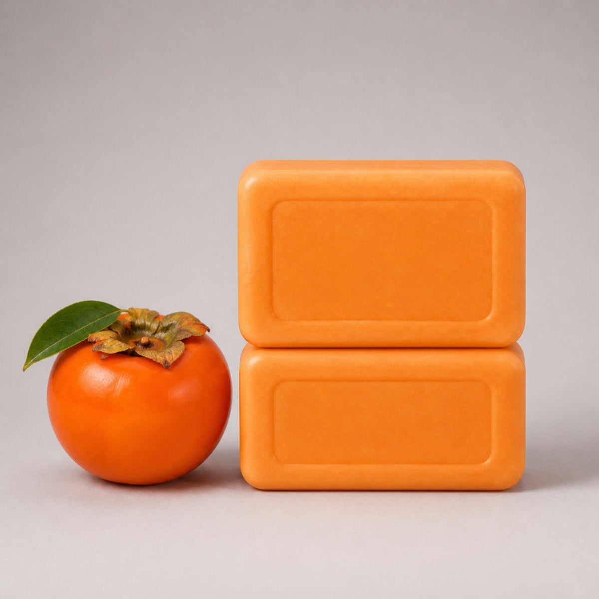 Vanigo Fresh Persimmon Deodorising Soap bars stacked neatly with a persimmon